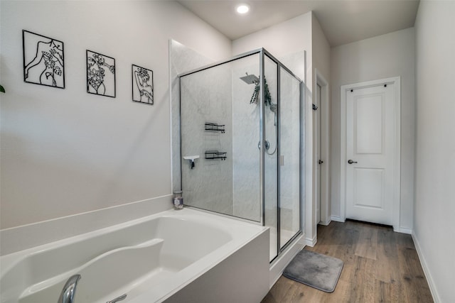 2016 Saddle Way, Mesquite, TX 75149 - bathroom featuring a bath, a stall shower, and wood finished floors