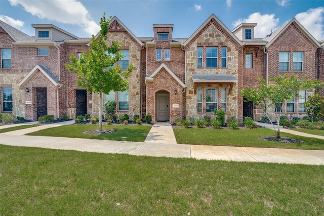 2016 Saddle Way, Mesquite, TX 75149 - townhome / multi-family property featuring stone siding, a front yard, and brick siding