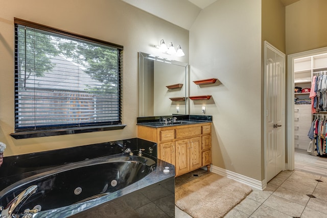 3231 Mccarver Ct, Midlothian, TX 76065 - bathroom featuring vanity, a whirlpool tub, a walk in closet, and tile patterned floors