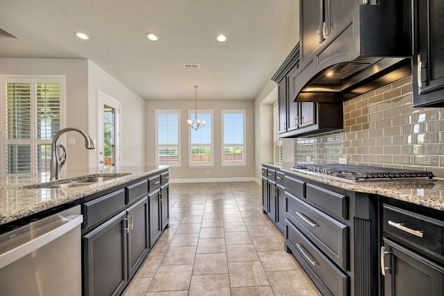 15005 Teasley Ave, Aledo, TX 76008 - kitchen with stainless steel appliances, under cabinet range hood, decorative backsplash, recessed lighting, and a chandelier