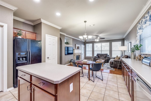 3504 Brookside Dr, Wylie, TX 75098 - kitchen featuring dishwasher, black fridge, a glass covered fireplace, ornamental molding, and a kitchen island