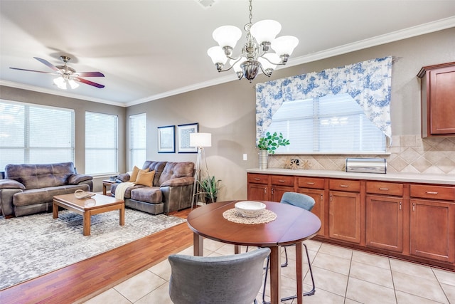 3504 Brookside Dr, Wylie, TX 75098 - living room with ornamental molding, healthy amount of natural light, light tile patterned floors, a chandelier, and a ceiling fan