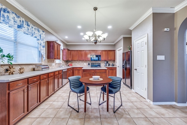 3504 Brookside Dr, Wylie, TX 75098 - kitchen featuring black appliances, a chandelier, backsplash, light countertops, and crown molding