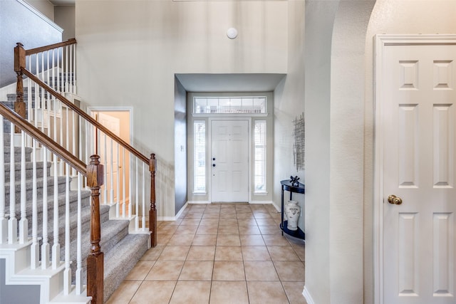 3504 Brookside Dr, Wylie, TX 75098 - foyer with light tile patterned floors, stairway, arched walkways, and a high ceiling