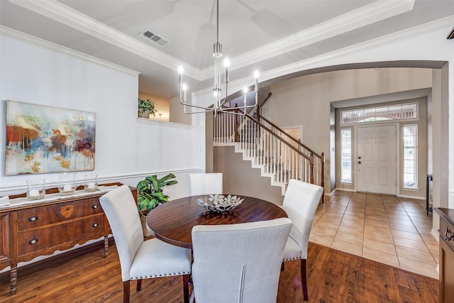3504 Brookside Dr, Wylie, TX 75098 - dining room with a chandelier, stairs, ornamental molding, wood finished floors, and arched walkways