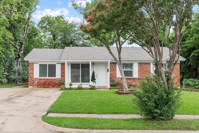 2203 Loyce Dr, Mesquite, TX 75149 - ranch-style home featuring brick siding, driveway, a front yard, and roof with shingles