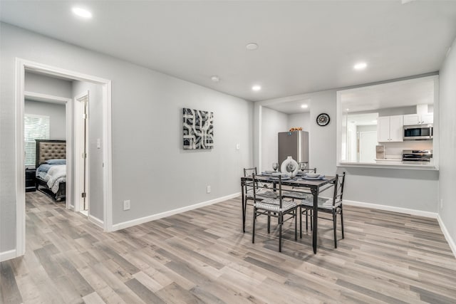 2203 Loyce Dr, Mesquite, TX 75149 - dining room with light wood finished floors and recessed lighting