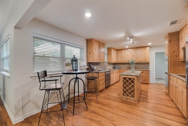 5820 Forest Ln, Dallas, TX 75230 - kitchen with dishwasher, light brown cabinetry, a kitchen island, tasteful backsplash, and recessed lighting