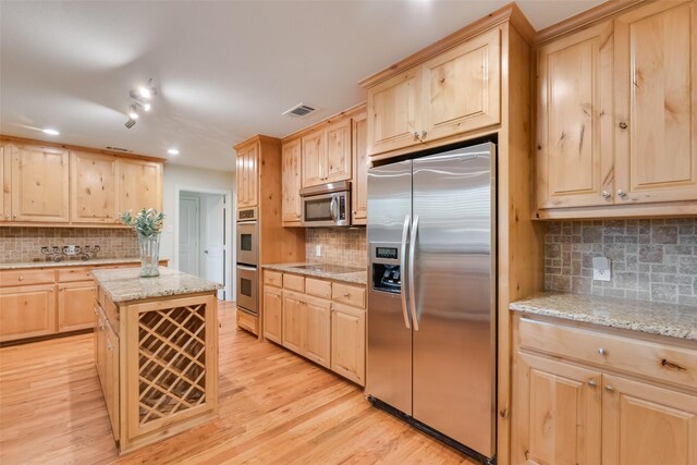 5820 Forest Ln, Dallas, TX 75230 - kitchen featuring stainless steel appliances, light brown cabinetry, tasteful backsplash, light wood-type flooring, and recessed lighting