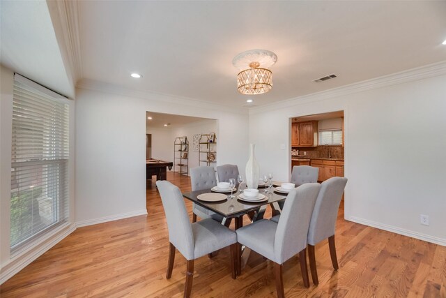 5820 Forest Ln, Dallas, TX 75230 - dining area with crown molding, a chandelier, light wood-style floors, and recessed lighting