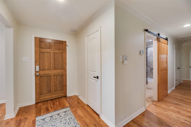 5820 Forest Ln, Dallas, TX 75230 - entryway featuring light wood-type flooring, ornamental molding, and a barn door