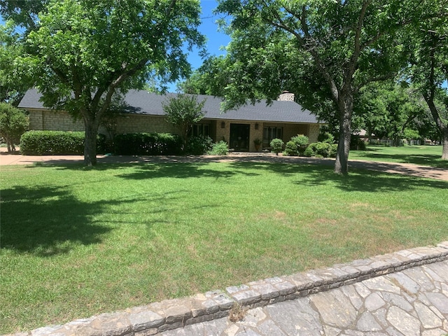 8918 Bellechase Rd, Granbury, TX 76049 - ranch-style house with a front yard and a chimney