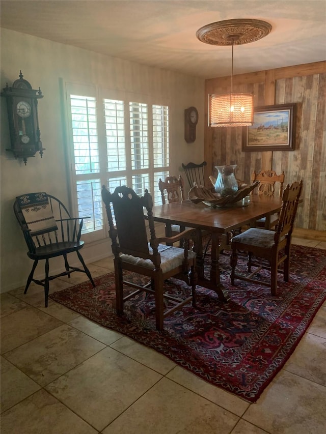 8918 Bellechase Rd, Granbury, TX 76049 - tiled dining space featuring wood walls and a chandelier