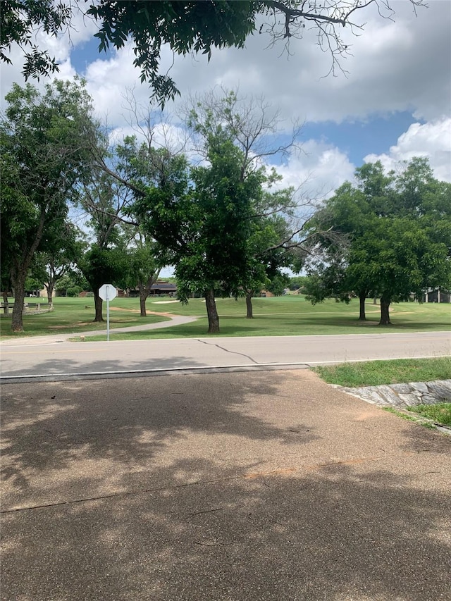 8918 Bellechase Rd, Granbury, TX 76049 - view of asphalt road featuring traffic signs