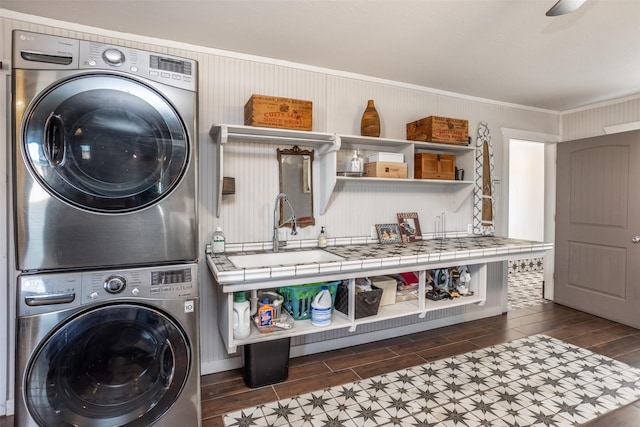 2473 Oil, City, Wilson, OK 73463 - laundry area with stacked washer / drying machine, wood finish floors, and ornamental molding