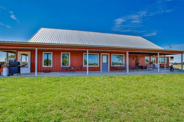 2473 Oil, City, Wilson, OK 73463 - back of house with a patio, a yard, board and batten siding, and a metal roof