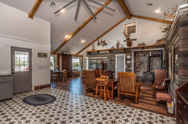 2473 Oil, City, Wilson, OK 73463 - dining area with a wood stove, beamed ceiling, high vaulted ceiling, and tile patterned floors