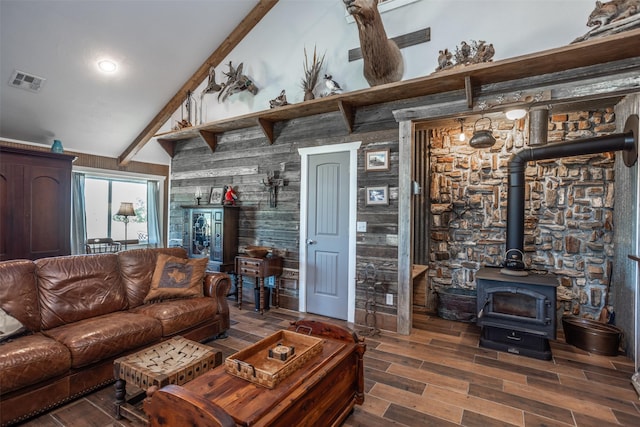 2473 Oil, City, Wilson, OK 73463 - living room featuring wood finished floors, vaulted ceiling, a wood stove, and wood walls