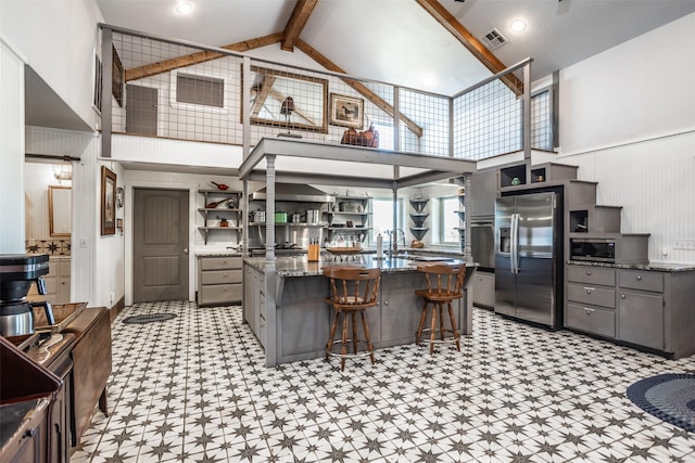 2473 Oil, City, Wilson, OK 73463 - kitchen featuring appliances with stainless steel finishes, gray cabinets, light floors, open shelves, and high vaulted ceiling
