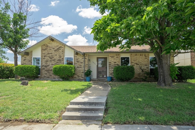 4933 N Colony Blvd, The Colony, TX 75056 - view of front of property featuring brick siding and a front lawn