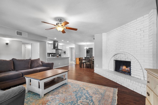 4933 N Colony Blvd, The Colony, TX 75056 - living room with a ceiling fan, wood finished floors, and a brick fireplace