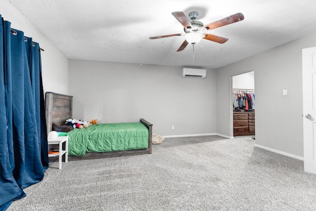 4933 N Colony Blvd, The Colony, TX 75056 - carpeted bedroom featuring a wall unit AC, a ceiling fan, and a spacious closet