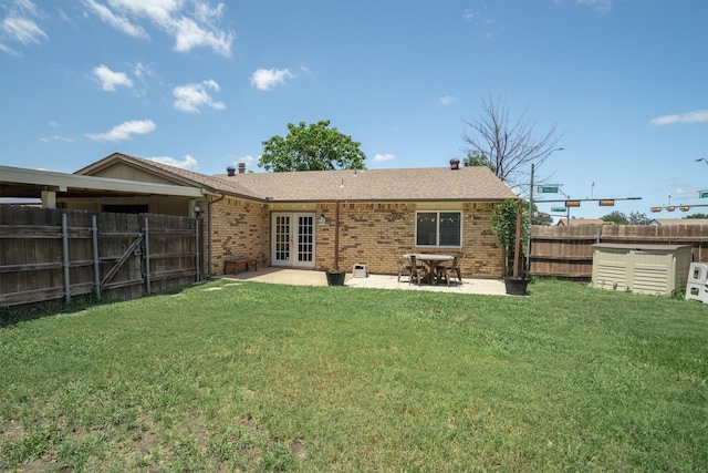 4933 N Colony Blvd, The Colony, TX 75056 - back of property with french doors, brick siding, a fenced backyard, a patio area, and a shingled roof
