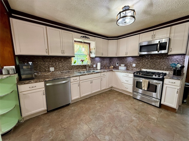 603 N Mesquite St, Hico, TX 76457 - kitchen featuring stainless steel appliances, decorative backsplash, a textured ceiling, white cabinets, and dark stone countertops