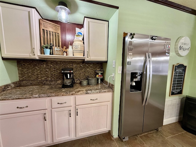 603 N Mesquite St, Hico, TX 76457 - kitchen featuring stainless steel fridge with ice dispenser, backsplash, white cabinetry, and tile patterned floors