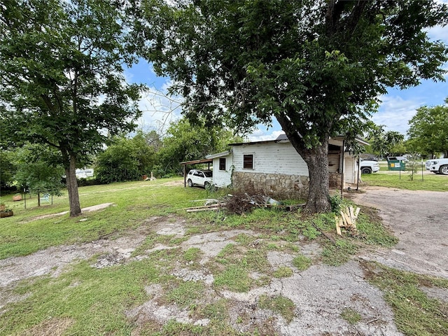 603 N Mesquite St, Hico, TX 76457 - view of side of home featuring stone siding and a yard