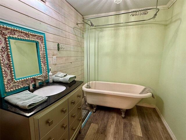 603 N Mesquite St, Hico, TX 76457 - bathroom featuring wood finished floors, vanity, and wood walls
