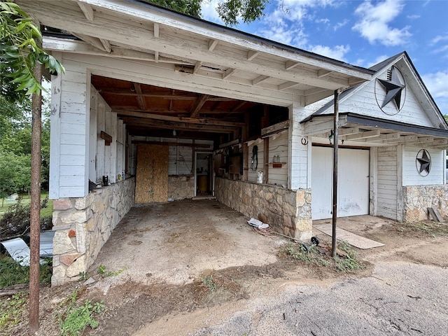 603 N Mesquite St, Hico, TX 76457 - view of home's exterior with stone siding, an outbuilding, and a garage