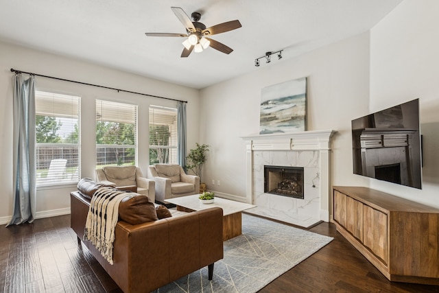 7105 Stoneridge Dr, Frisco, TX 75034 - living room featuring a premium fireplace, dark wood finished floors, ceiling fan, and healthy amount of natural light