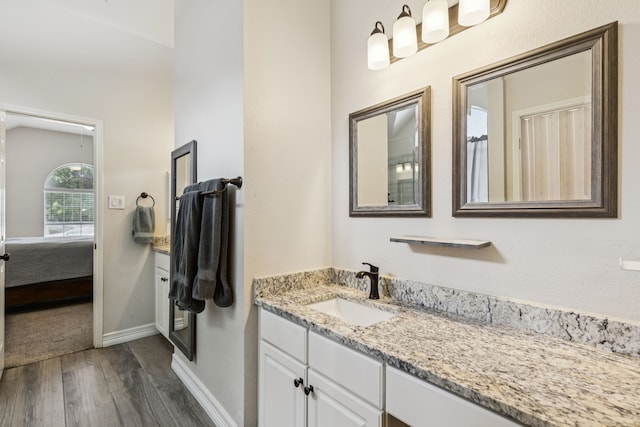 7105 Stoneridge Dr, Frisco, TX 75034 - full bath featuring wood finished floors, vanity, and ensuite bath