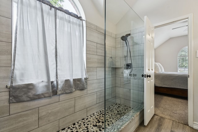 7105 Stoneridge Dr, Frisco, TX 75034 - ensuite bathroom featuring vaulted ceiling, walk in shower, and wood finished floors