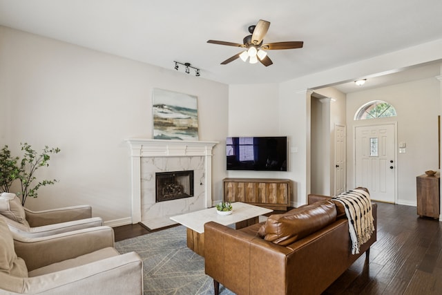 7105 Stoneridge Dr, Frisco, TX 75034 - living room with a ceiling fan, dark wood-style floors, a high end fireplace, and rail lighting