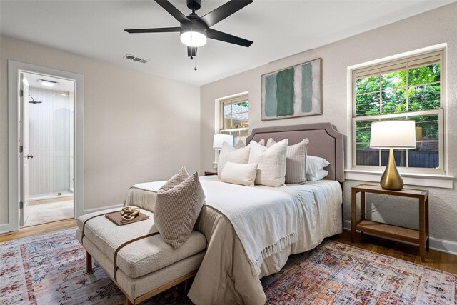 10017 Lanshire Dr, Dallas, TX 75238 - bedroom featuring wood finished floors, ensuite bath, and a ceiling fan