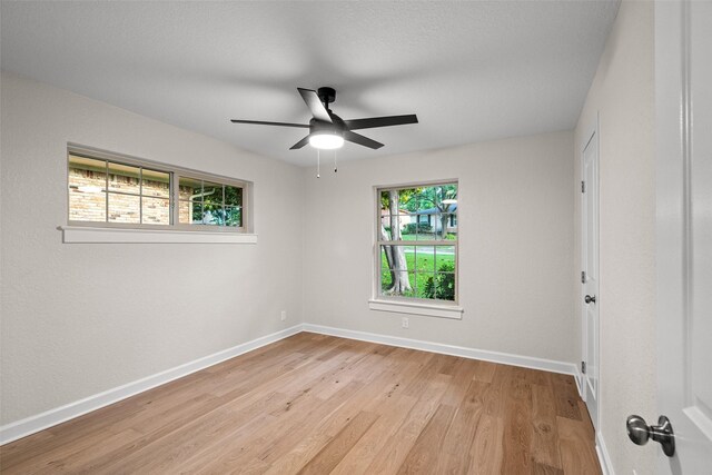 10017 Lanshire Dr, Dallas, TX 75238 - empty room with wood finished floors and ceiling fan