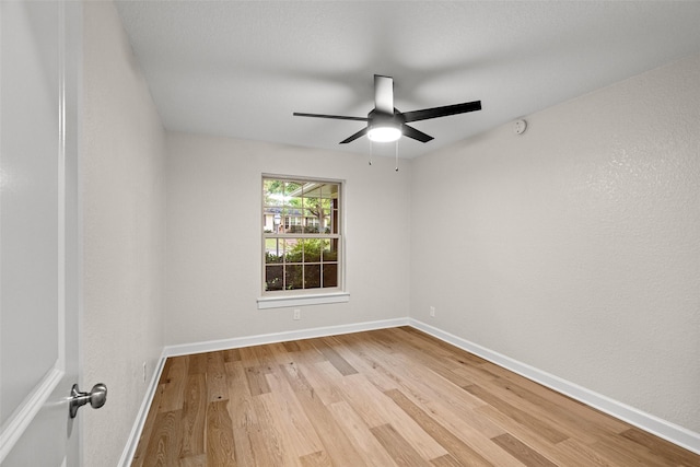 10017 Lanshire Dr, Dallas, TX 75238 - empty room with light wood-style flooring, a ceiling fan, and a smoke detector
