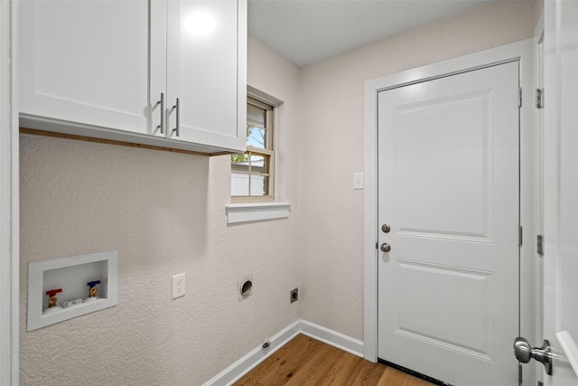 10017 Lanshire Dr, Dallas, TX 75238 - laundry room featuring hookup for a washing machine, cabinet space, wood finished floors, and hookup for an electric dryer