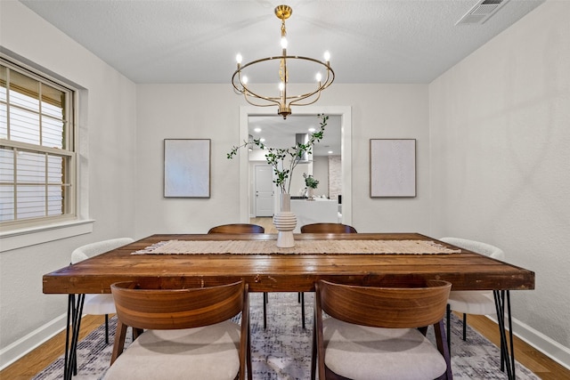 10017 Lanshire Dr, Dallas, TX 75238 - dining space featuring a chandelier and wood finished floors