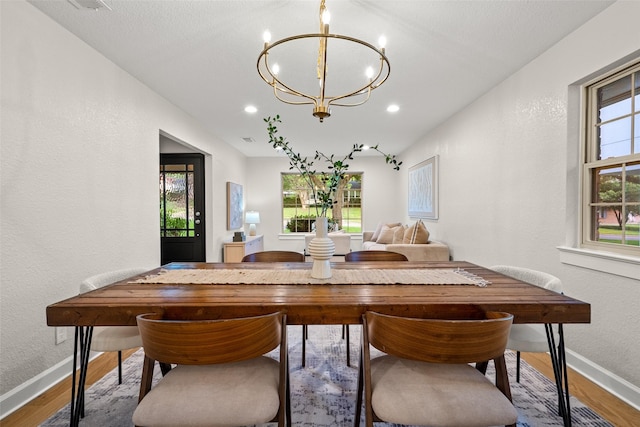 10017 Lanshire Dr, Dallas, TX 75238 - dining area with wood finished floors, a chandelier, a textured wall, and recessed lighting