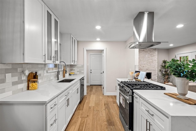 10017 Lanshire Dr, Dallas, TX 75238 - kitchen featuring gas range, ventilation hood, light wood-style floors, decorative backsplash, and white cabinets
