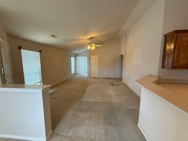 6437 Regina Dr, Fort Worth, TX 76131 - unfurnished living room with lofted ceiling, arched walkways, ceiling fan, and light colored carpet