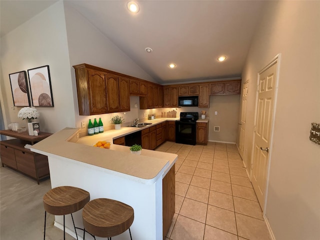 6437 Regina Dr, Fort Worth, TX 76131 - kitchen featuring black appliances, a peninsula, light countertops, vaulted ceiling, and recessed lighting