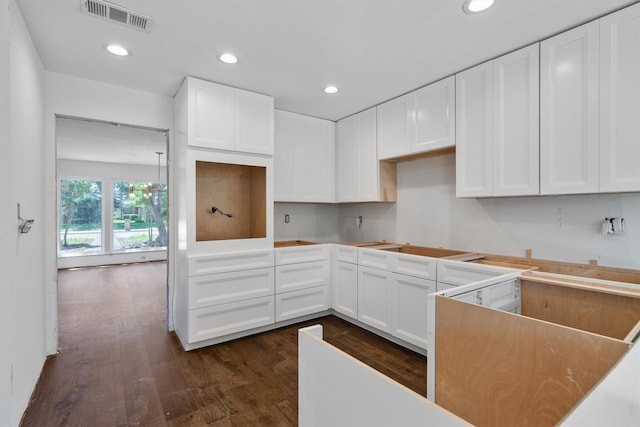 4209 Brooktree Ln, Dallas, TX 75287 - kitchen with dark wood-type flooring, recessed lighting, and white cabinetry