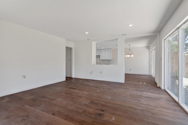 4209 Brooktree Ln, Dallas, TX 75287 - unfurnished living room featuring a chandelier, dark wood-style floors, and recessed lighting