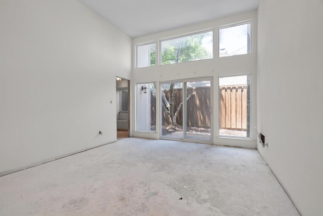 4209 Brooktree Ln, Dallas, TX 75287 - spare room with a towering ceiling and concrete flooring