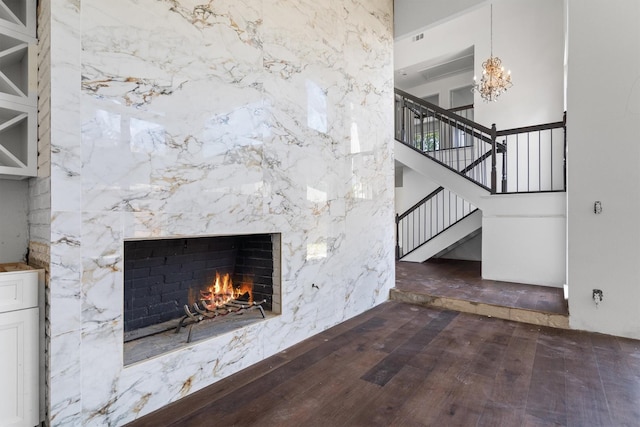 4209 Brooktree Ln, Dallas, TX 75287 - unfurnished living room with a high end fireplace, a chandelier, stairway, wood finished floors, and a high ceiling