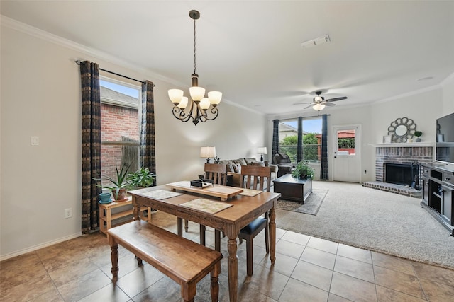 7732 Anatolian Way, Fort Worth, TX 76131 - dining area featuring ornamental molding, light tile patterned flooring, a chandelier, ceiling fan, and a brick fireplace